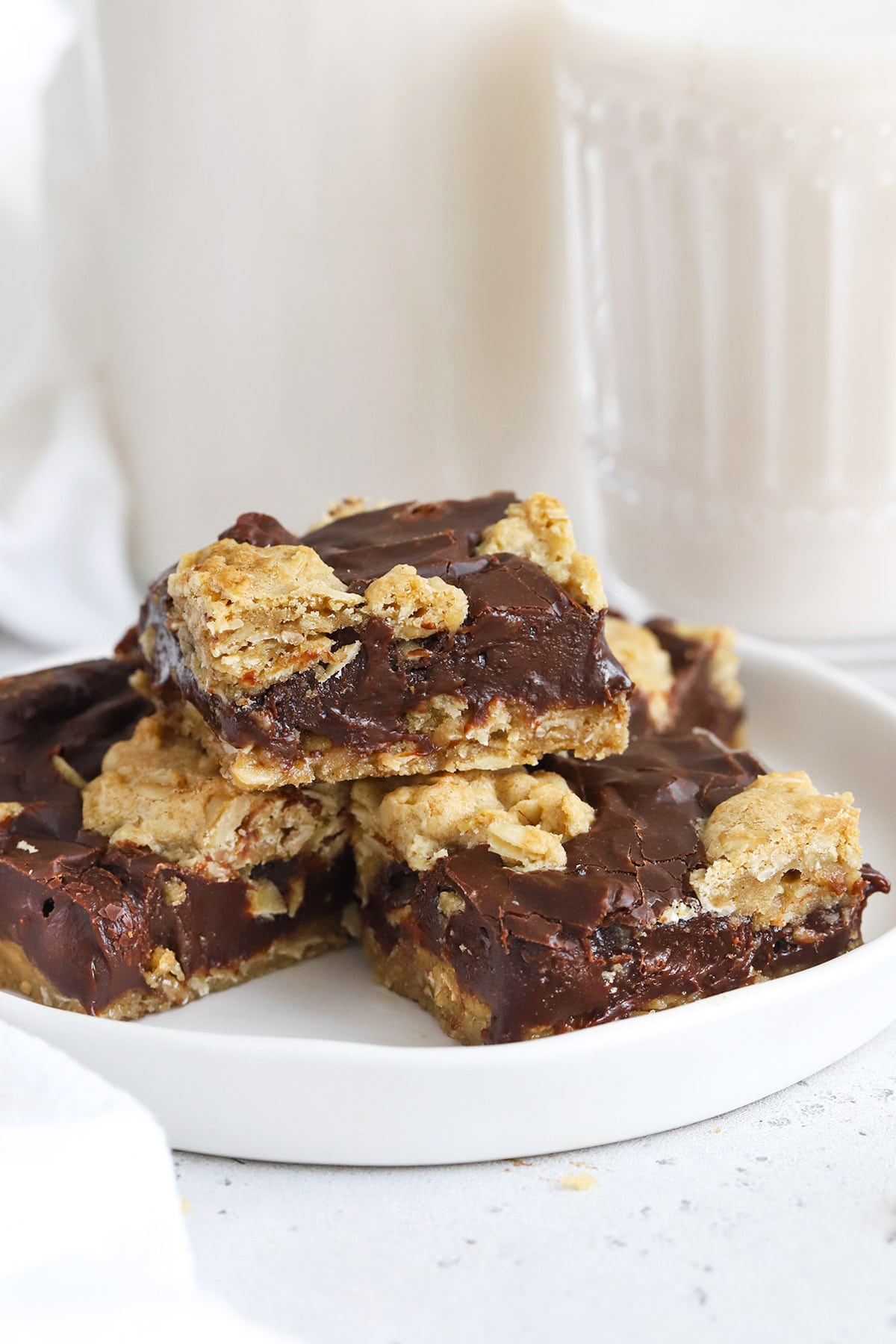 Gluten-Free oatmeal fudge bars cut into squares and stacked on a plate