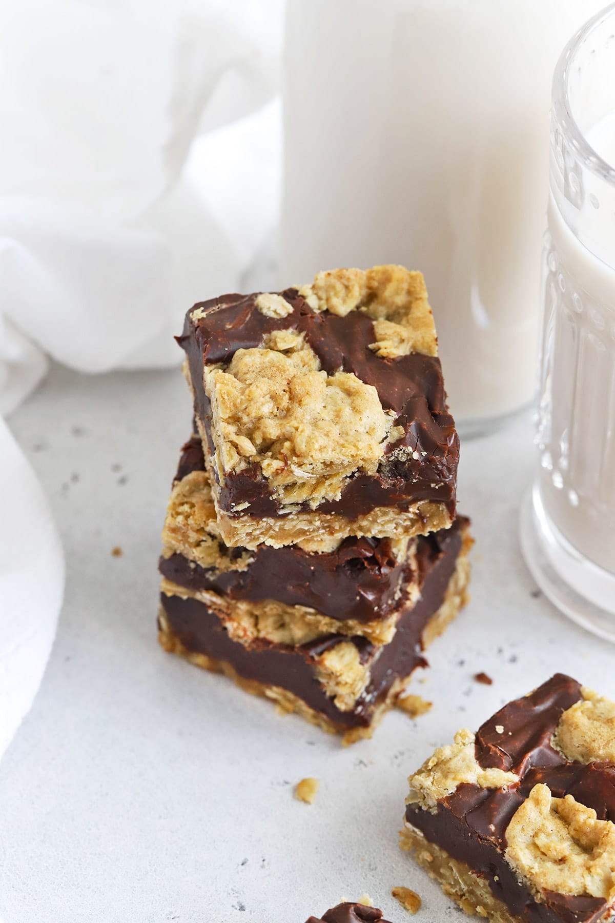 Gluten-Free Oatmeal Fudge Bars Stacked on a white backdrop