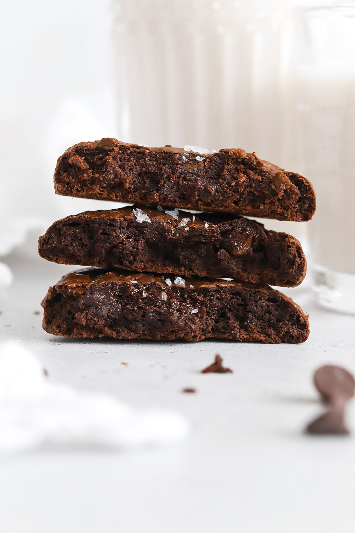 gluten-free chocolate brownie cookies broken in half, revealing their fudgy center