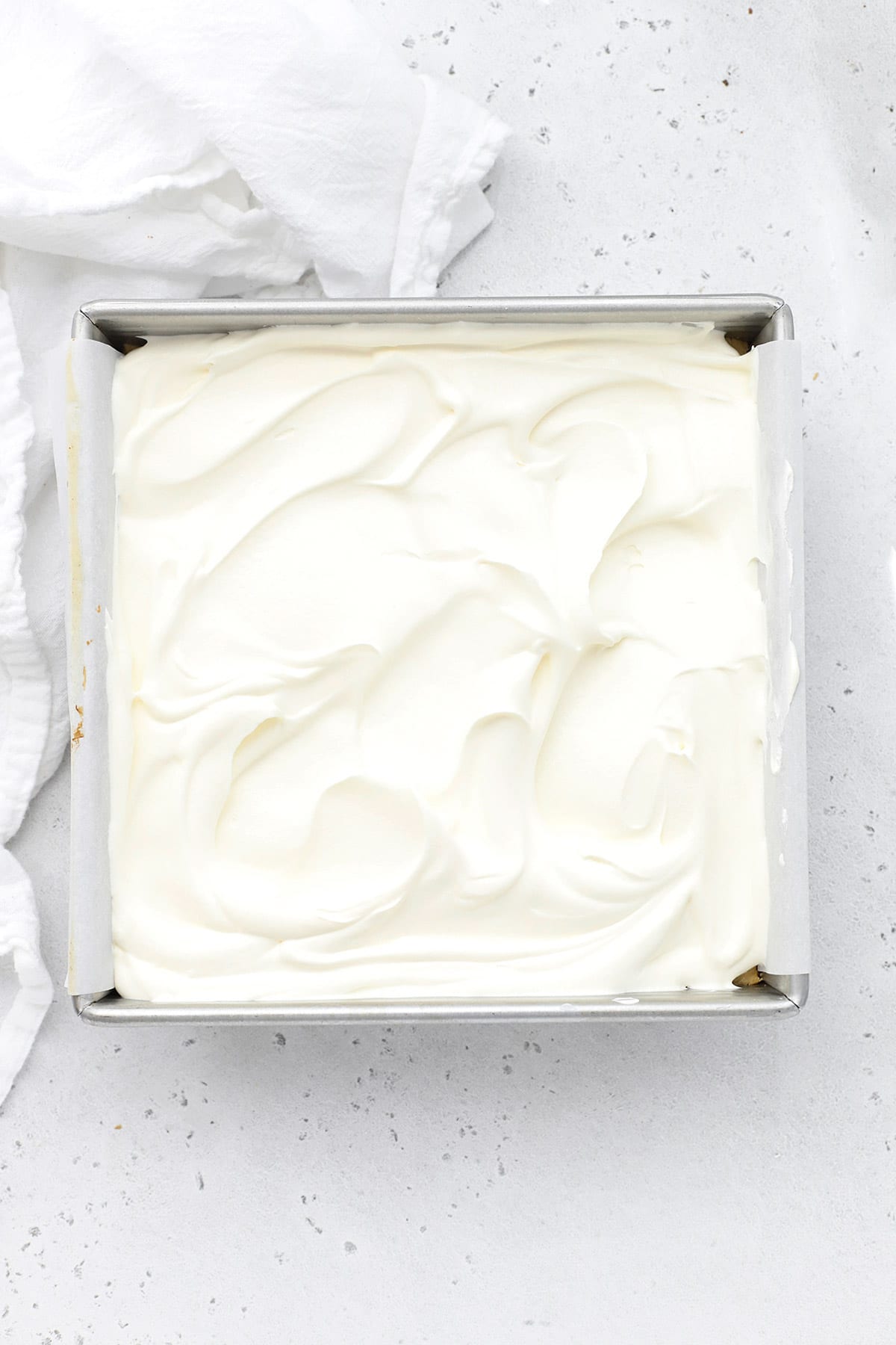 Swirls of whipped cream on top of gluten-free key lime pie bars