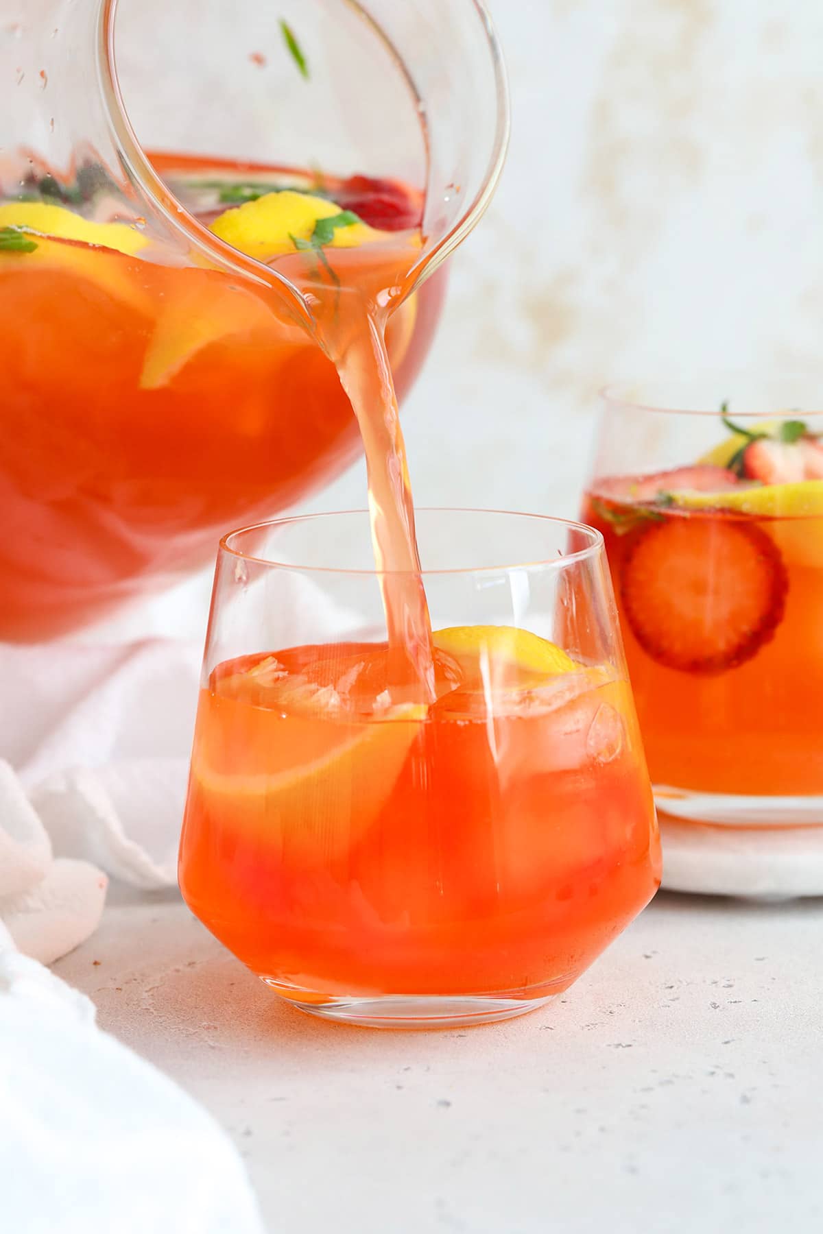 Pouring a glass of strawberry basil lemonade