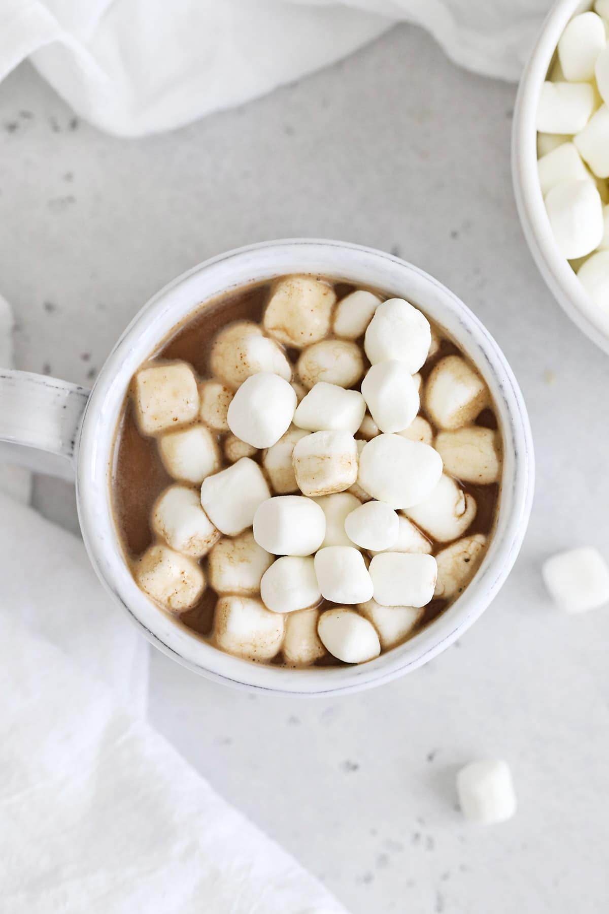Overhead view of a mug of hot chocolate topped with mini marshmallows