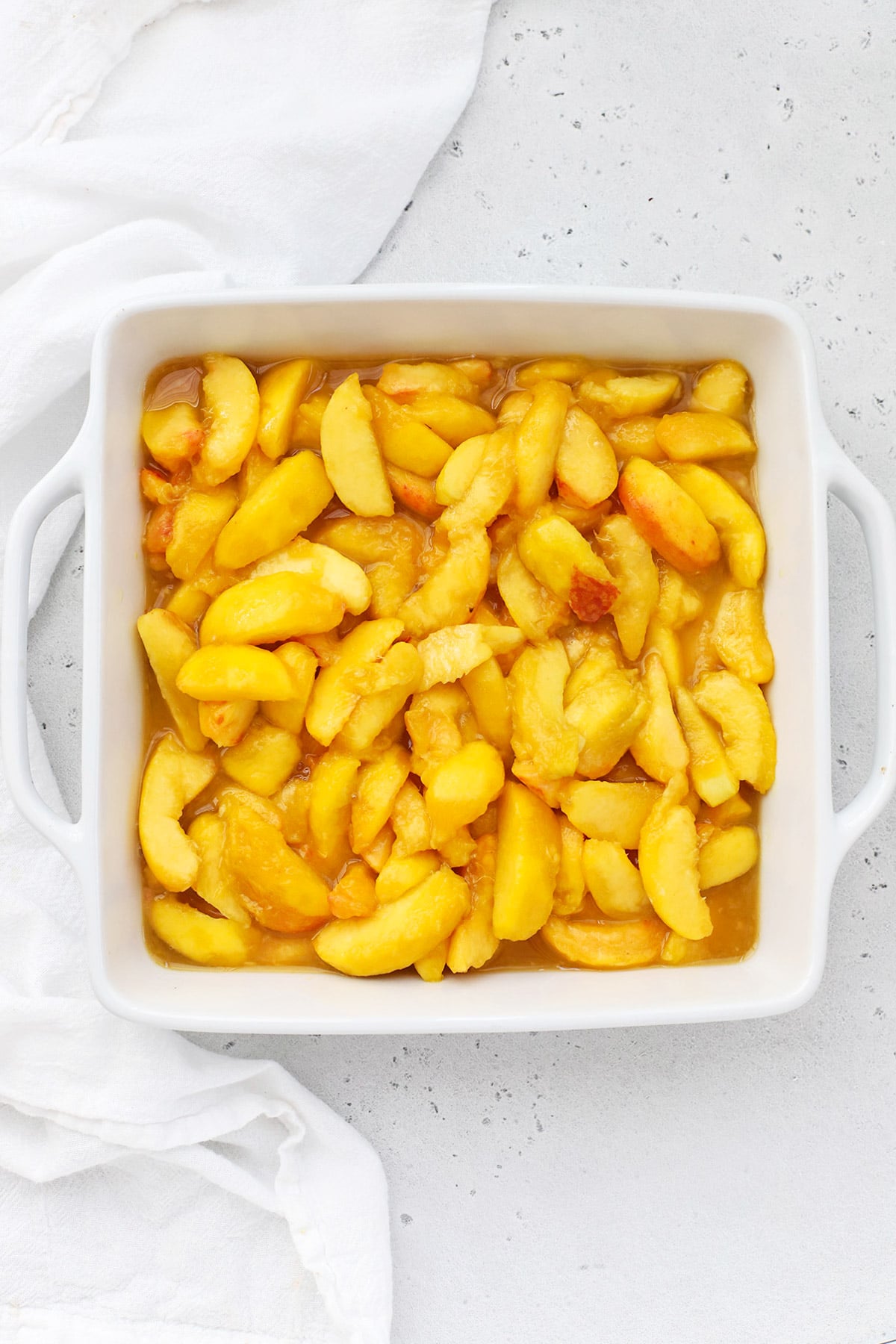 overhead view of gluten-free peach filling in a baking dish
