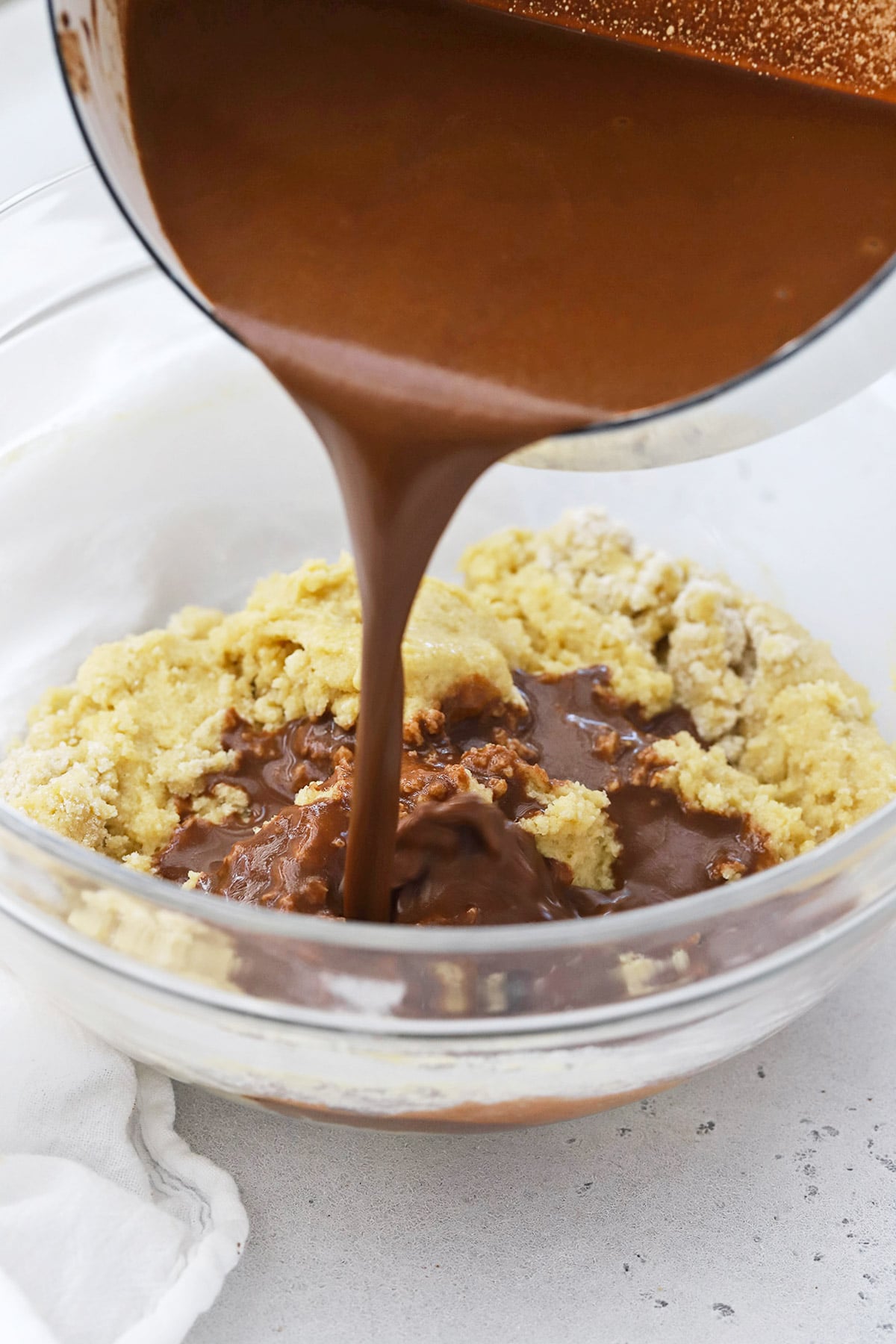 Pouring melted cocoa and butter into texas sheet cake batter