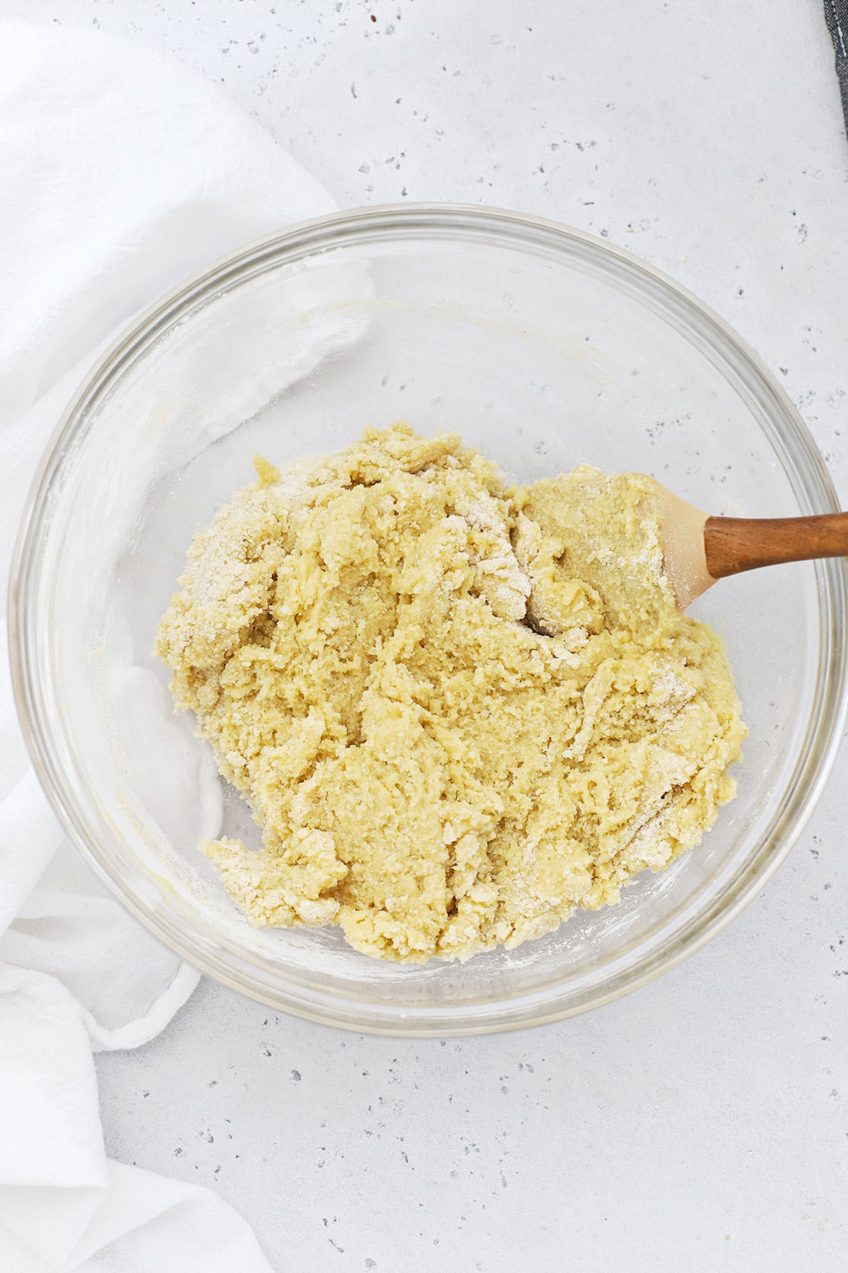mixing eggs and sour cream into gluten-free texas sheet cake batter