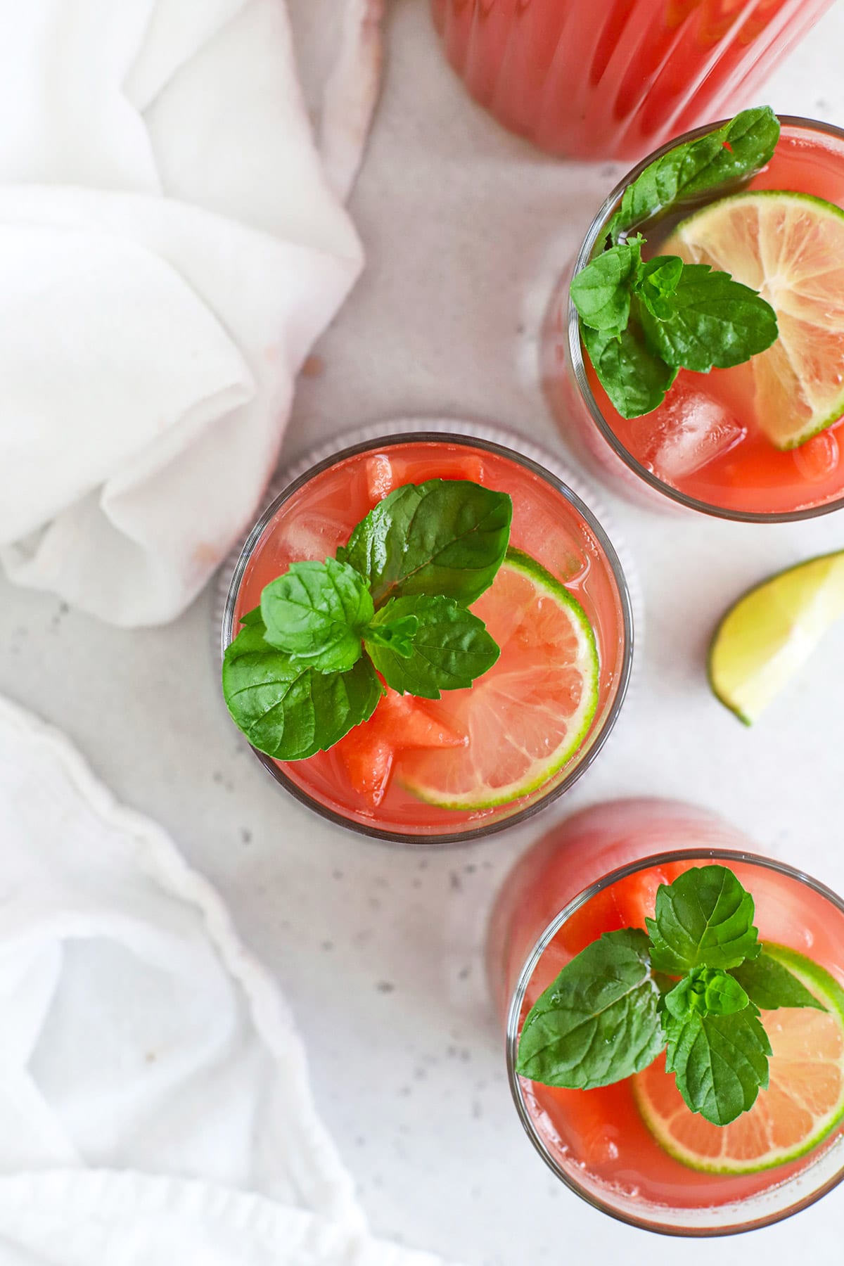 Overhead view of Watermelon Agua Fresca (Agua de Sandia) garnished with watermelon, lime, and mint