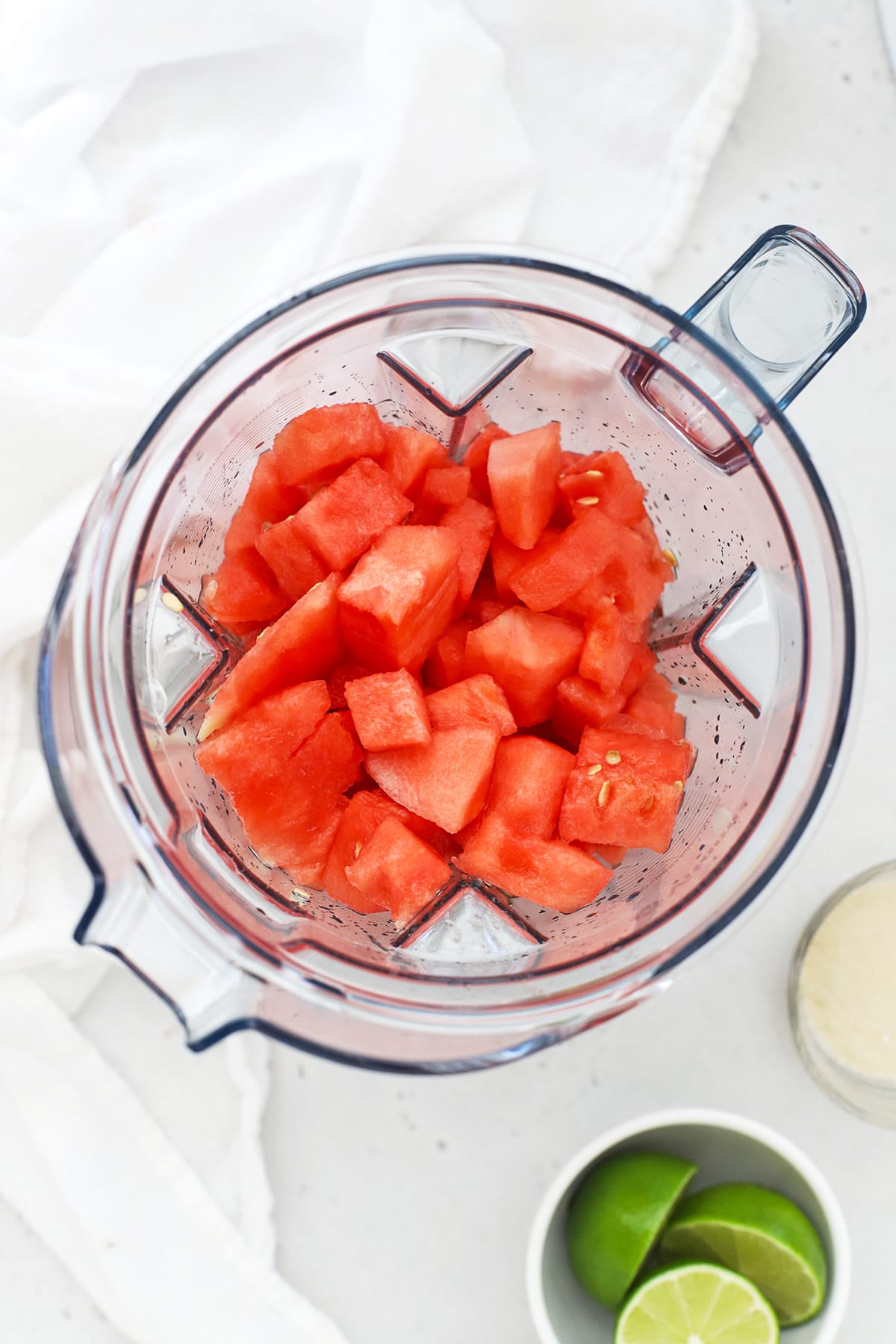 Adding watermelon to a blender to make agua de sandia (watermelon agua fresca)
