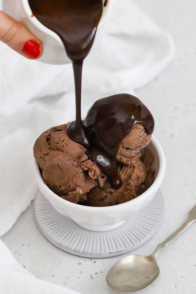 Drizzling homemade chocolate syrup over chocolate ice cream