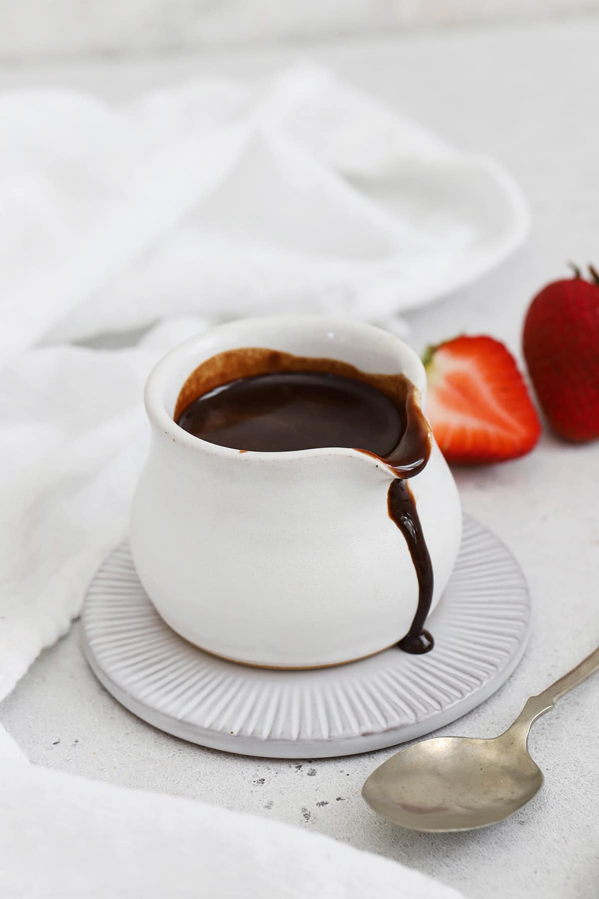 A small white pitcher of homemade chocolate syrup