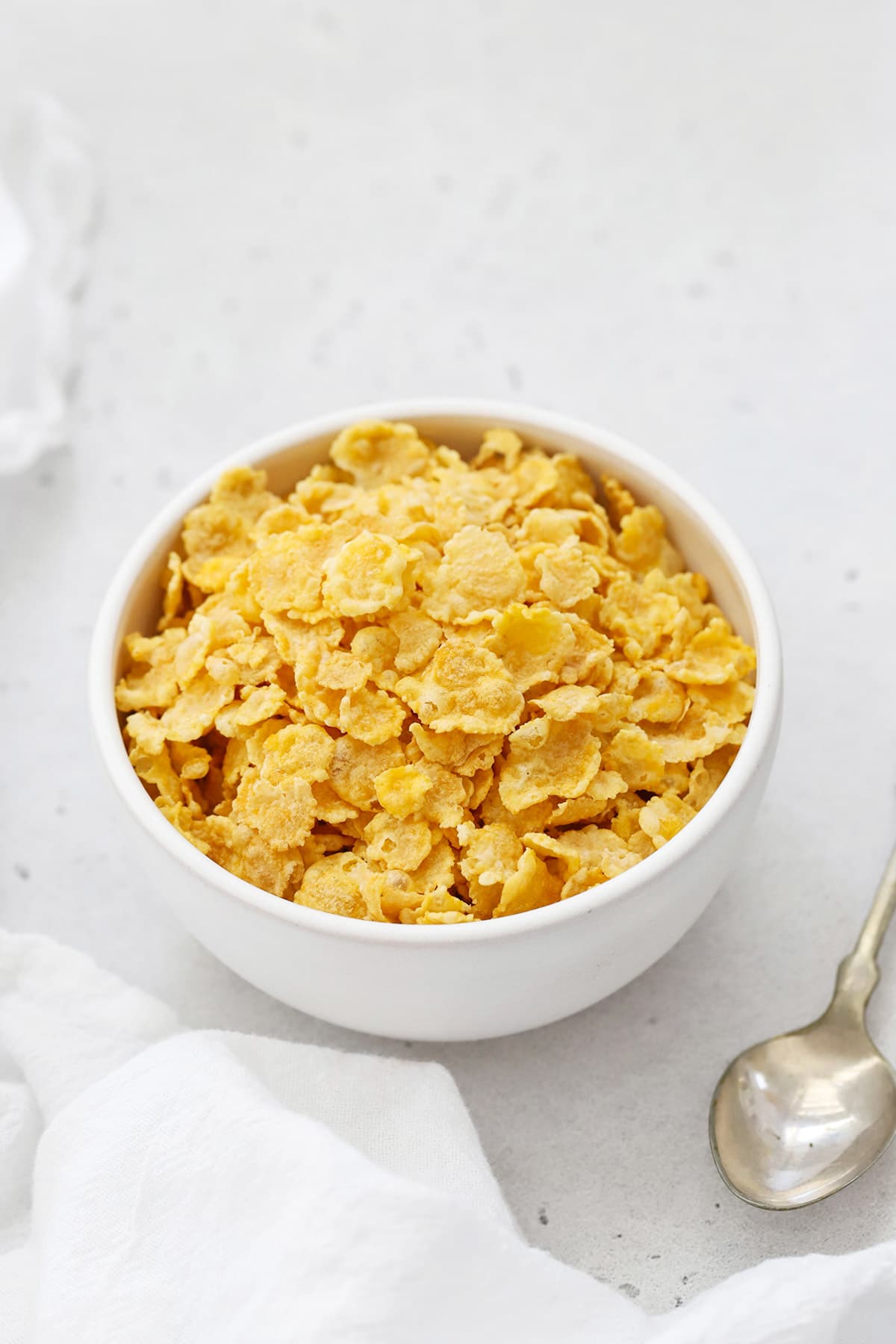 Overhead view of a white bowl of gluten free corn flakes