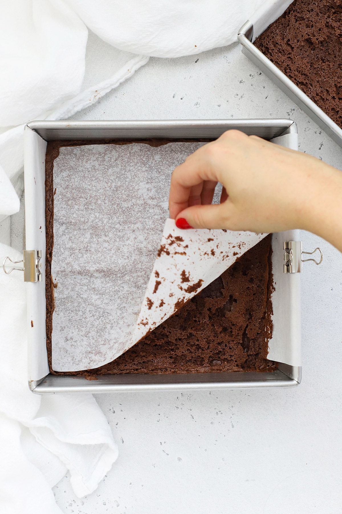 pulling the parchment off of gluten-free brownies