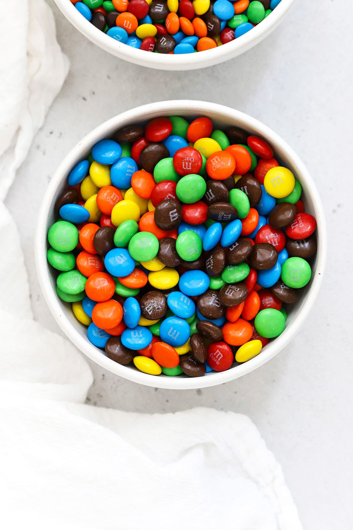Overhead bowl of colorful m&ms in a white bowl