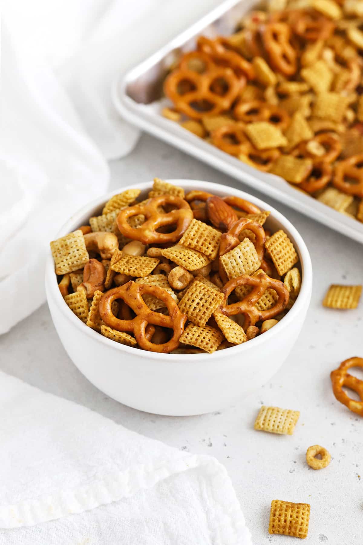 Front view of a bowl of easy gluten-free Chex Mix on a white background