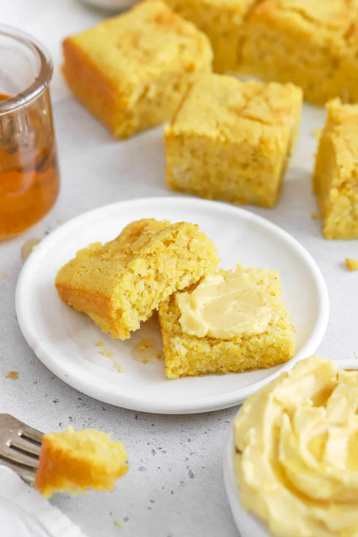 Front view of gluten-free cornbread spread with whipped honey butter