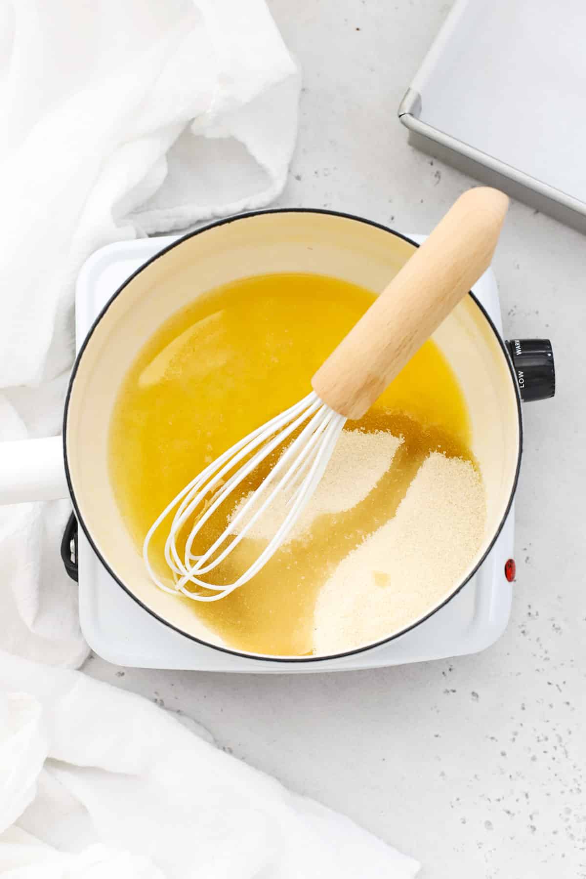 Melting butter, oil, and sugar for gluten-free m&m brownies