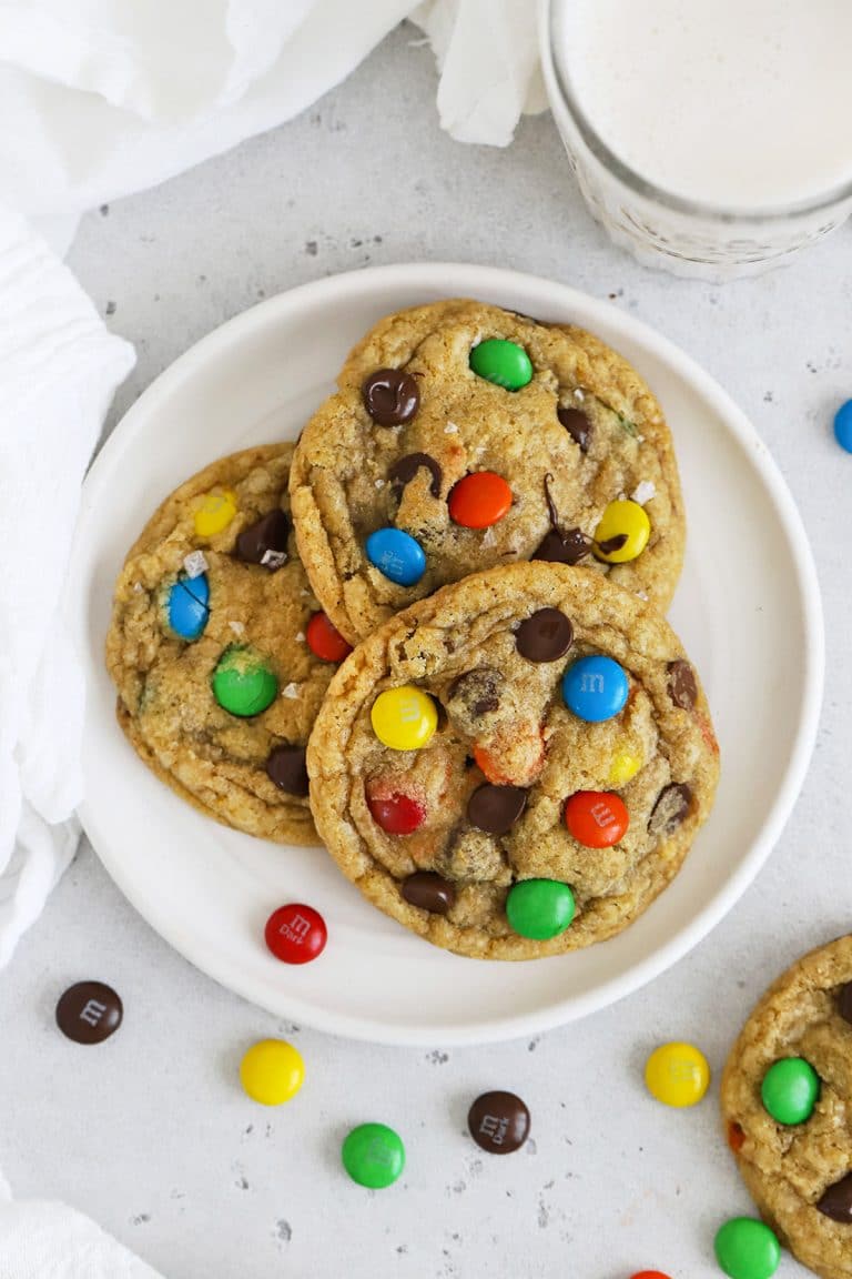 Overhead view of three gluten-free M&M cookies on a plate