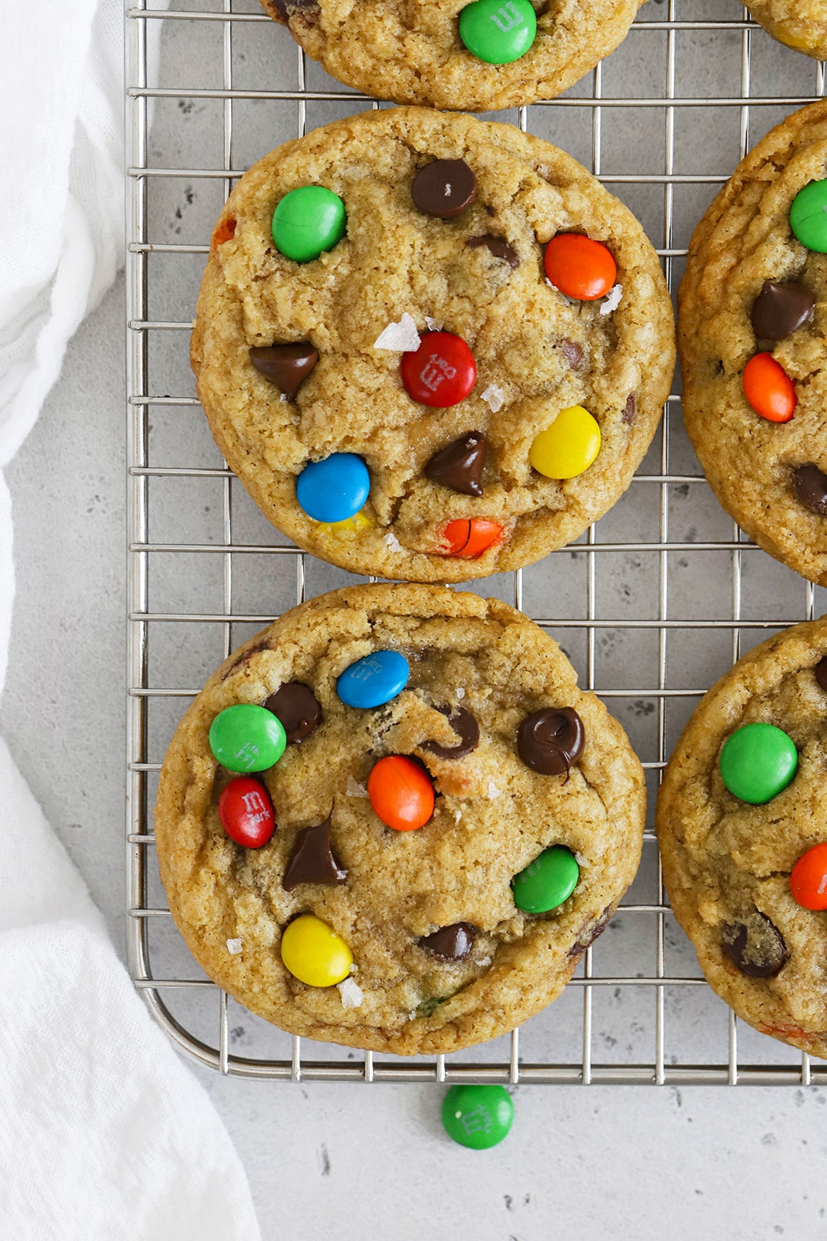 Overhead view of soft, chewy gluten-free m&m cookies cooling on a wire rack