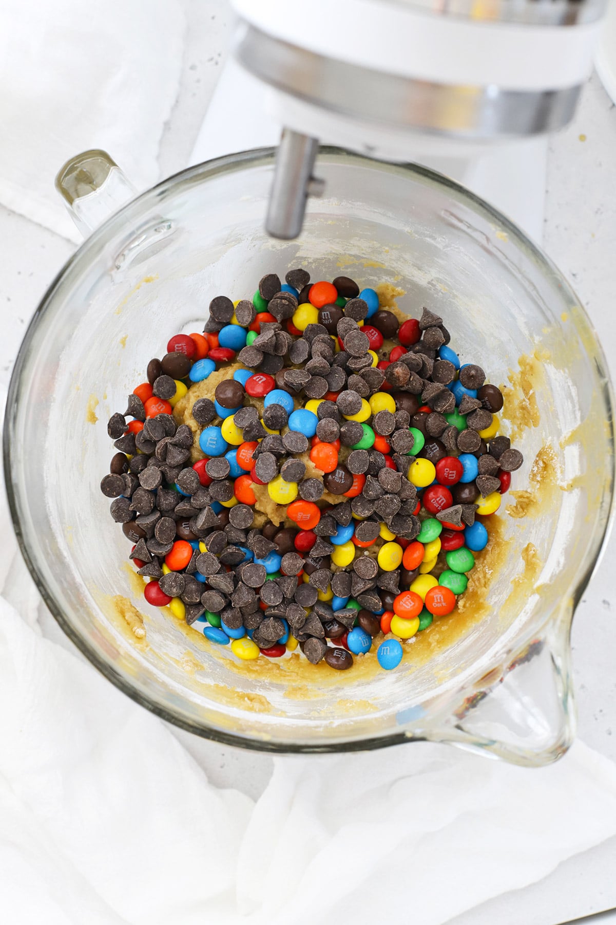 Adding M&Ms and chocolate chips to gluten-free m&m cookie dough