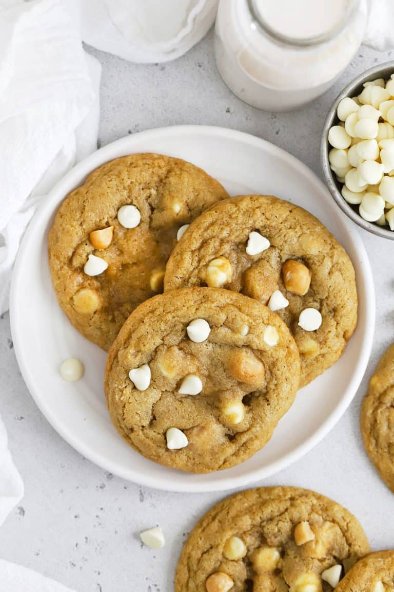 Overhead view of three gluten-free white chocolate chip macadamia nut cookies on a plate