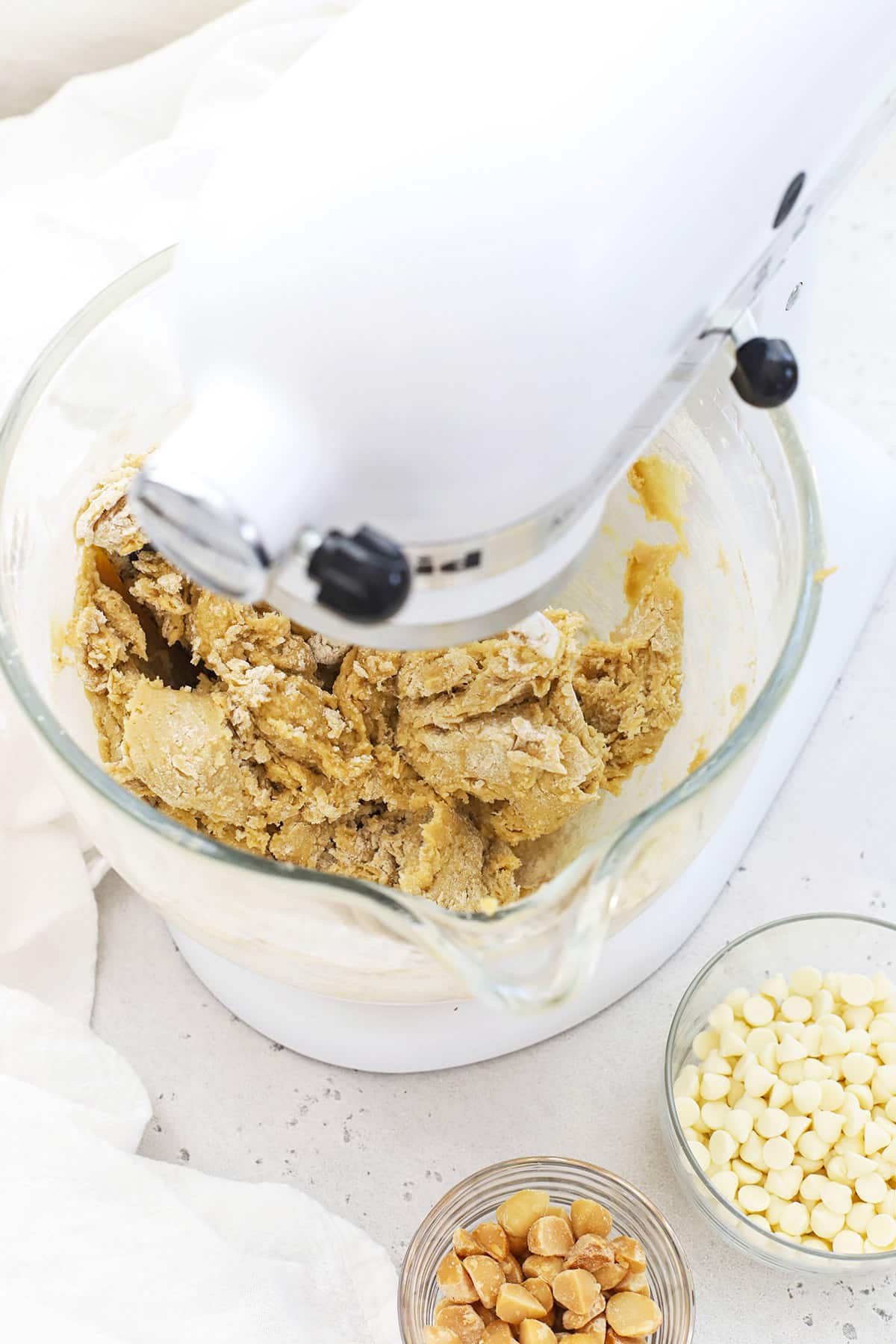 Mixing dry ingredients into gluten-free macadamia nut cookie dough