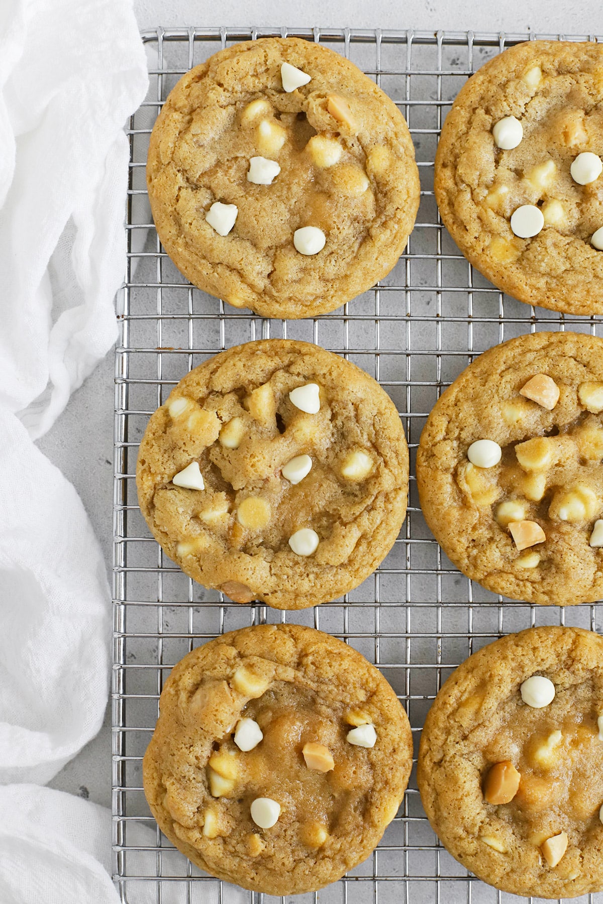 Overhead view of gluten-free white chocolate macadamia cookies on a cooling rack