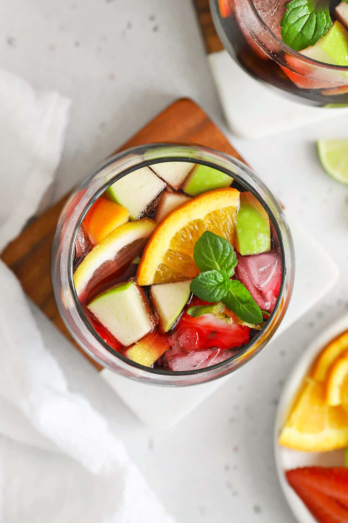 Overhead view of a glass of non-alcoholic sangria with fresh fruit