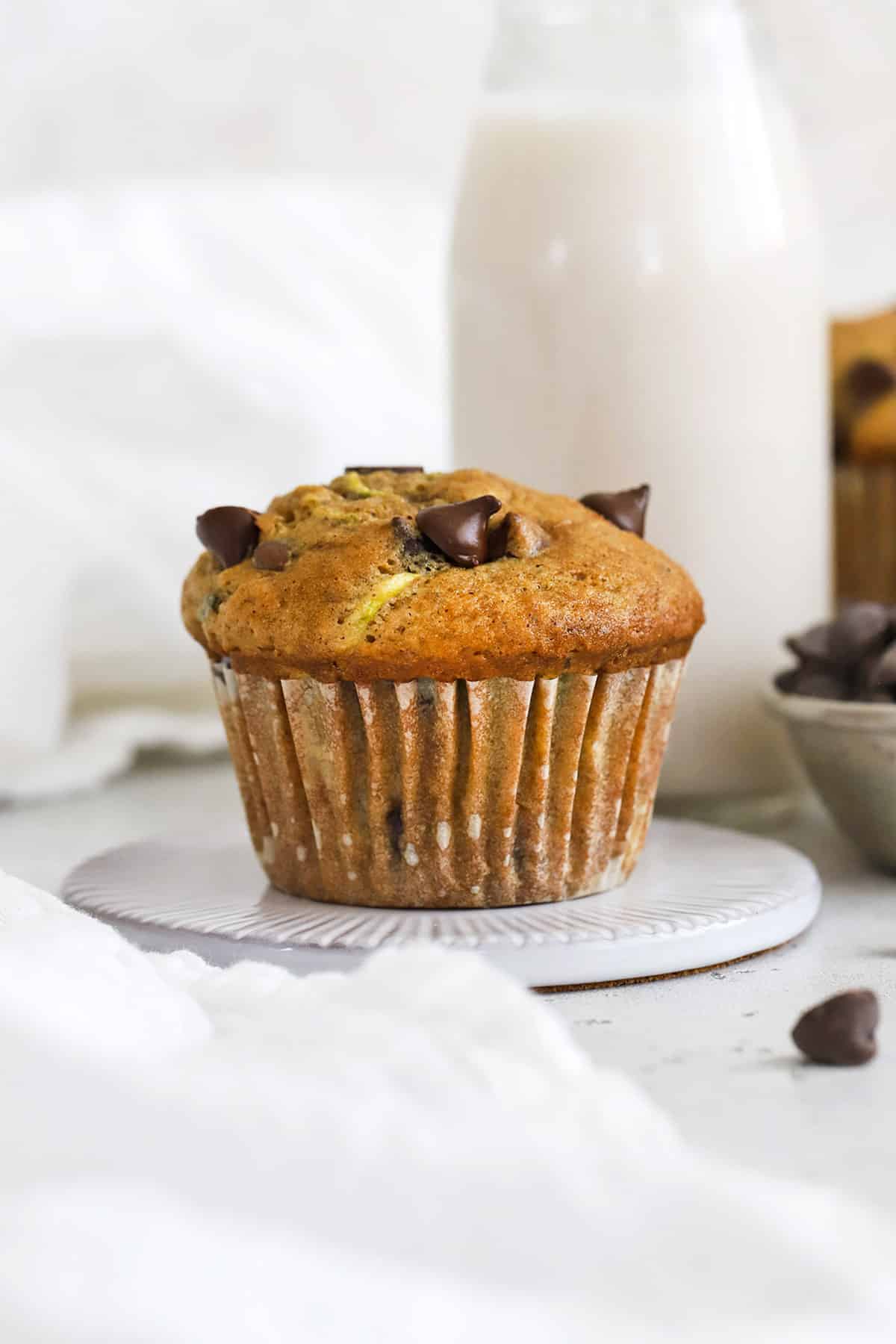 Front view of a moist gluten-free zucchini muffin with chocolate chips