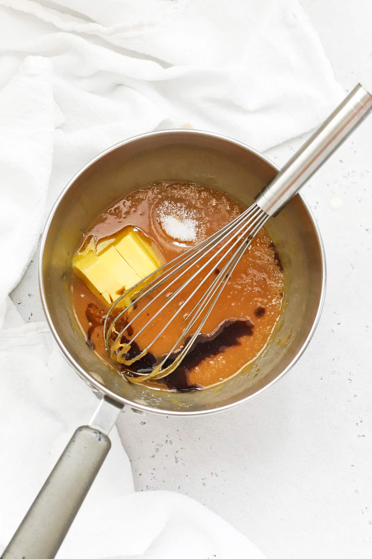Whisking butter, salt, and vanilla into caramel