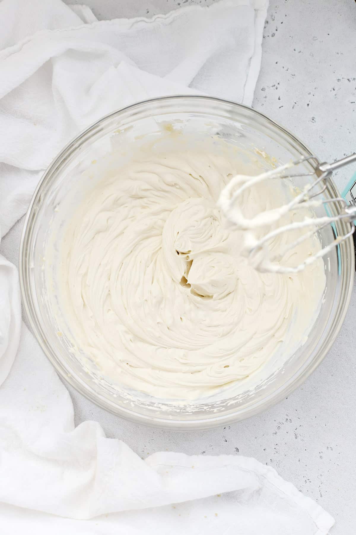 Overhead view of whipped cream cheese frosting in a bowl