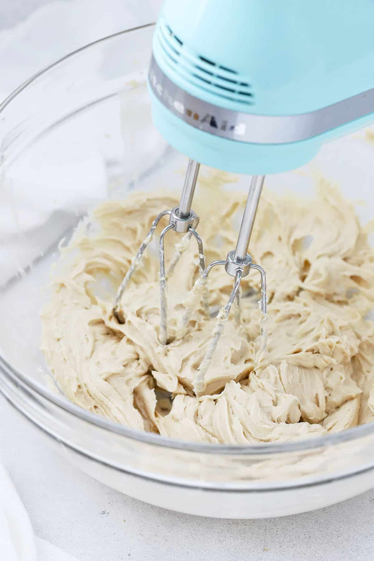 Beating whipped cream cheese frosting