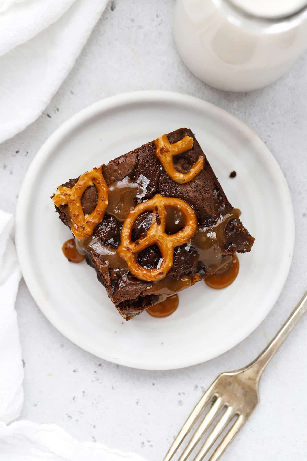 A gluten-free caramel pretzel brownie on a plate