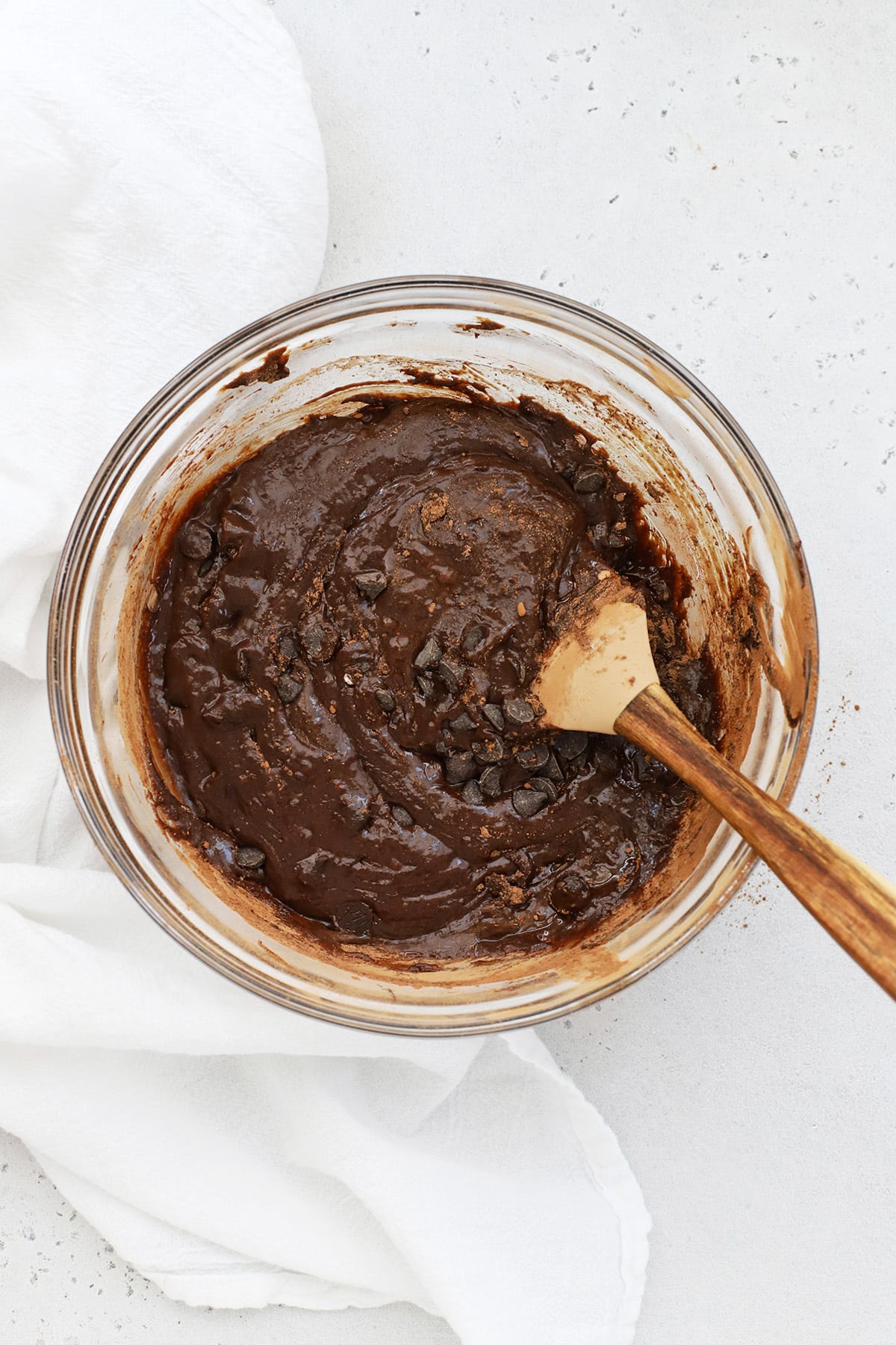 Stirring chocolate chips into gluten-free brownie batter