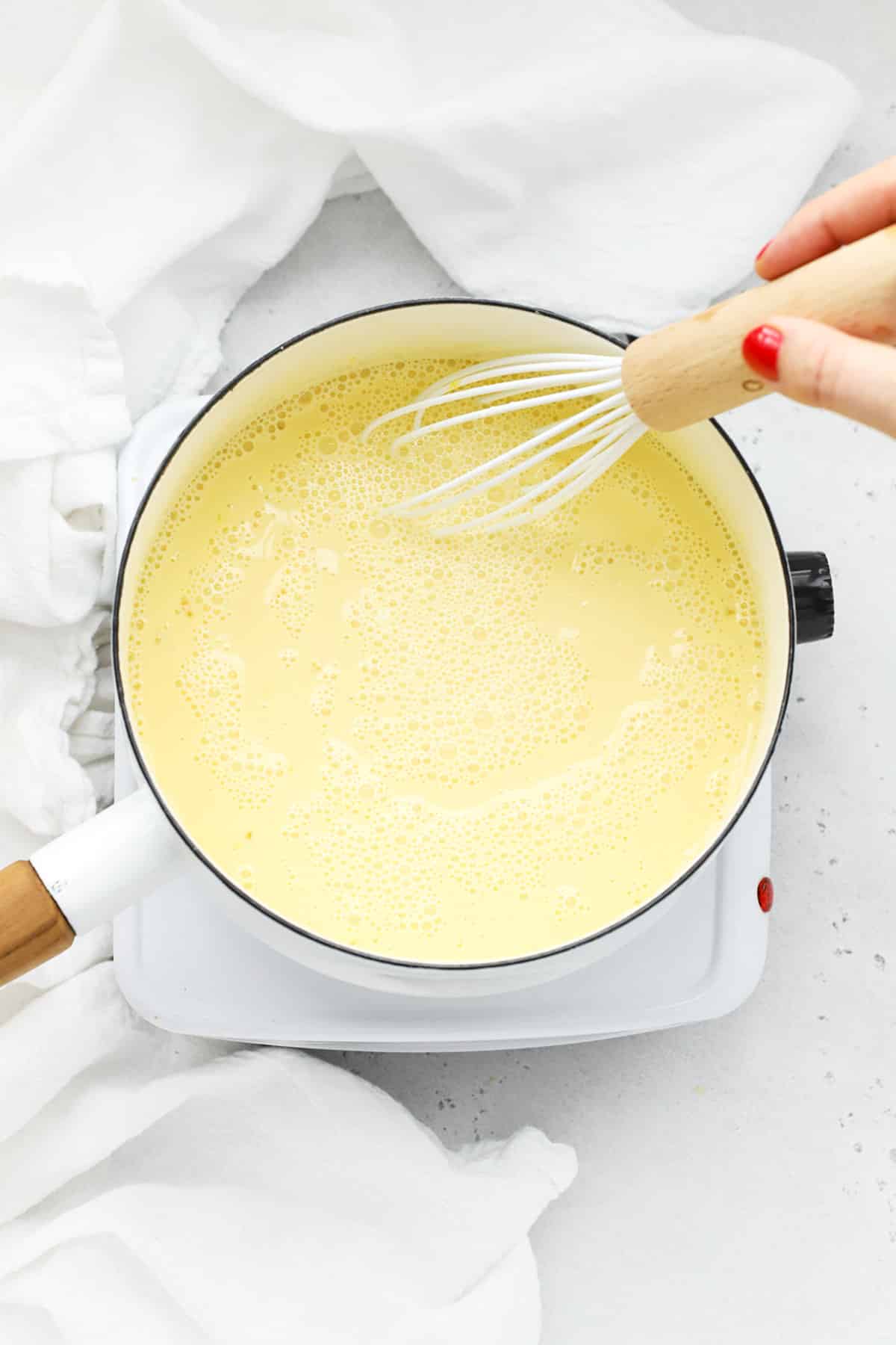 Stirring custard to make gluten-free banana cream pie