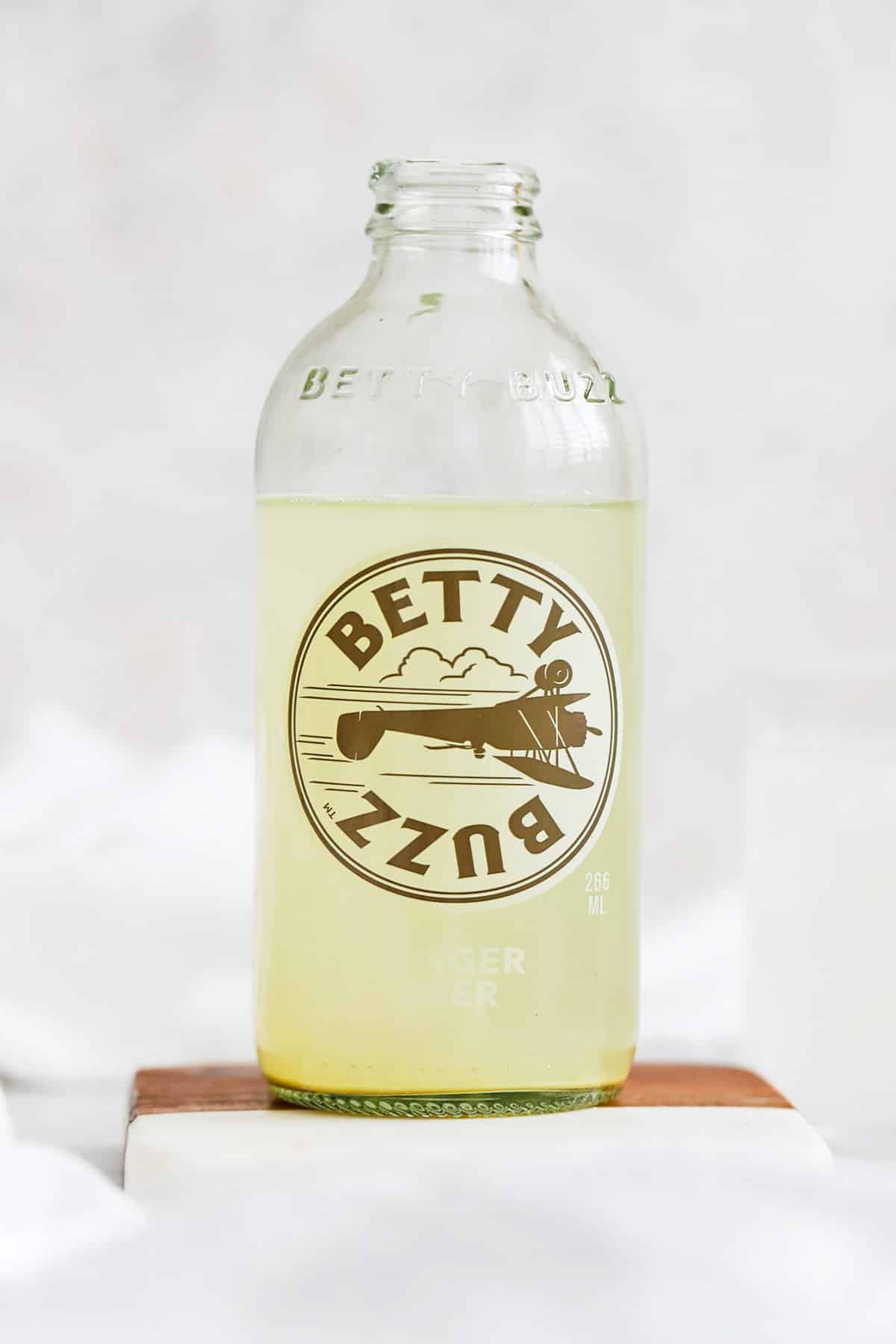 front view of a bottle of betty buzz ginger beer
