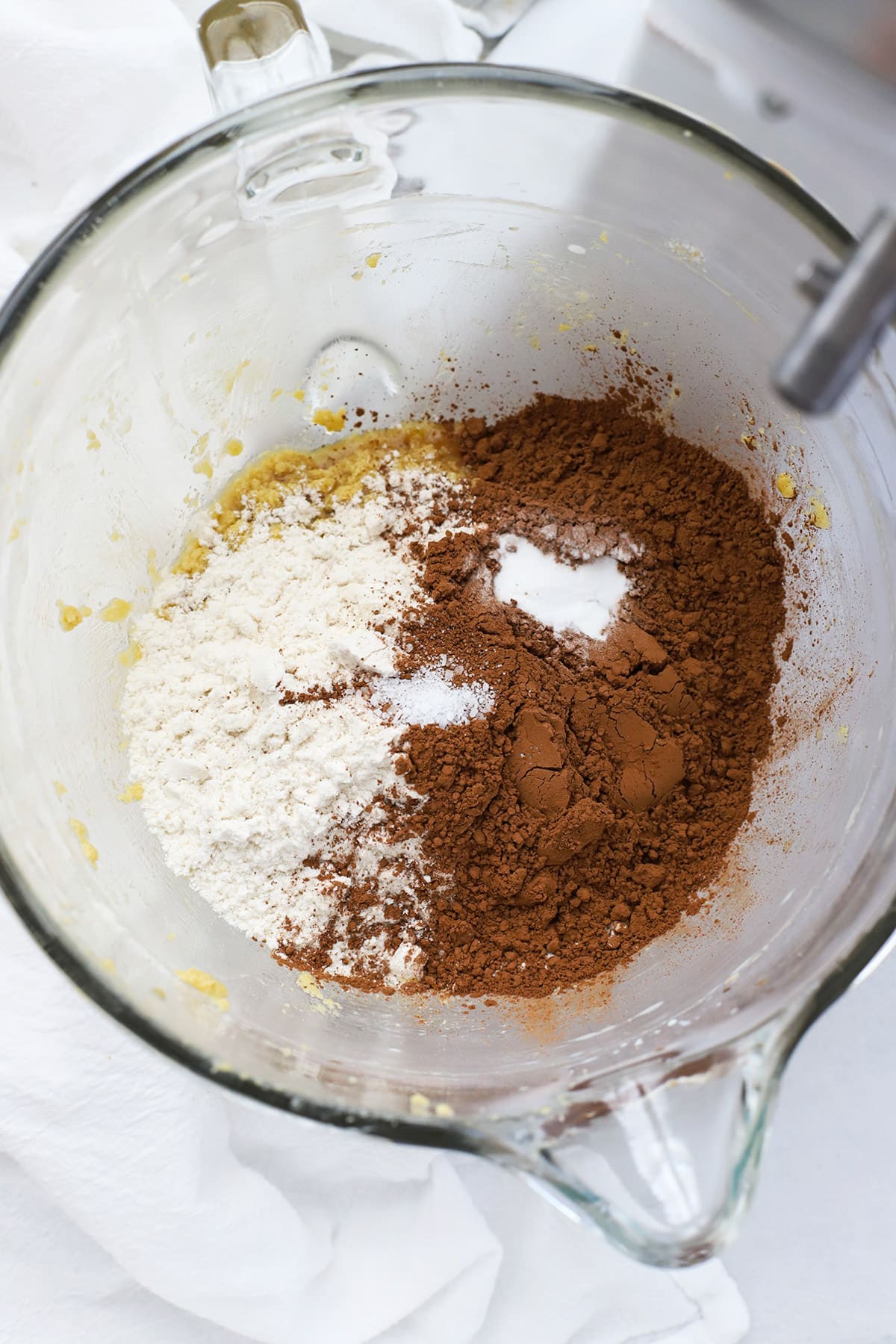adding dry ingredients to gluten-free chocolate cookie dough