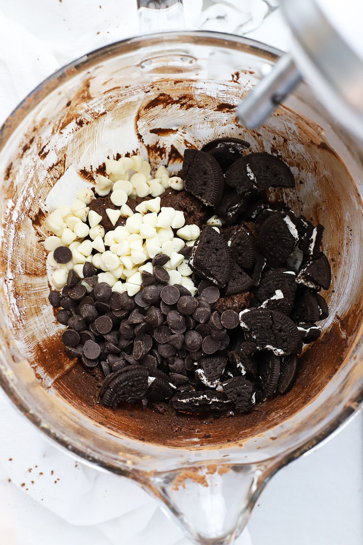adding white chocolate chips, semisweet chocolate chips and chopped gluten-free oreos to gluten-free chocolate cookie batter