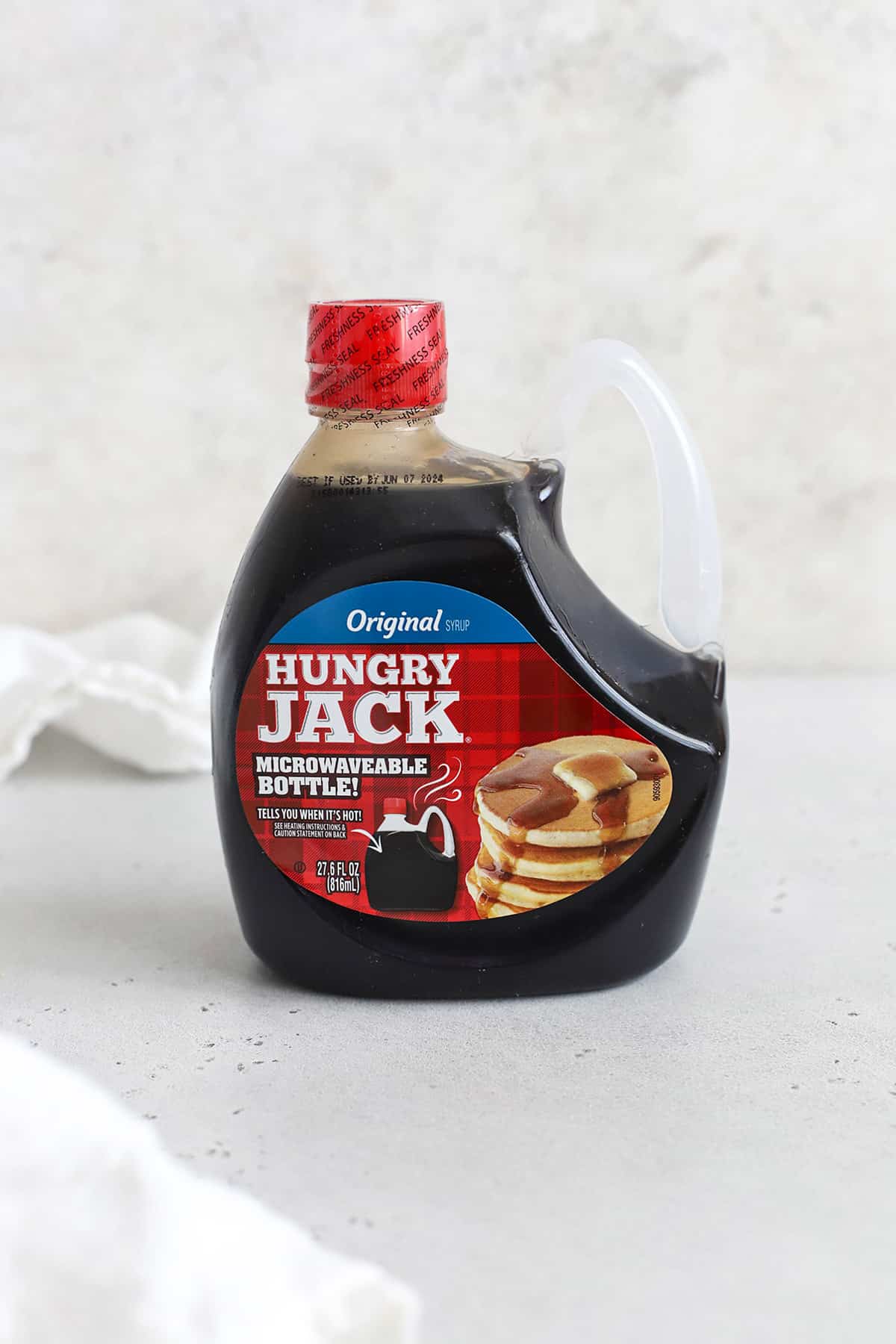 Front view of a bottle of hungry jack pancake syrup
