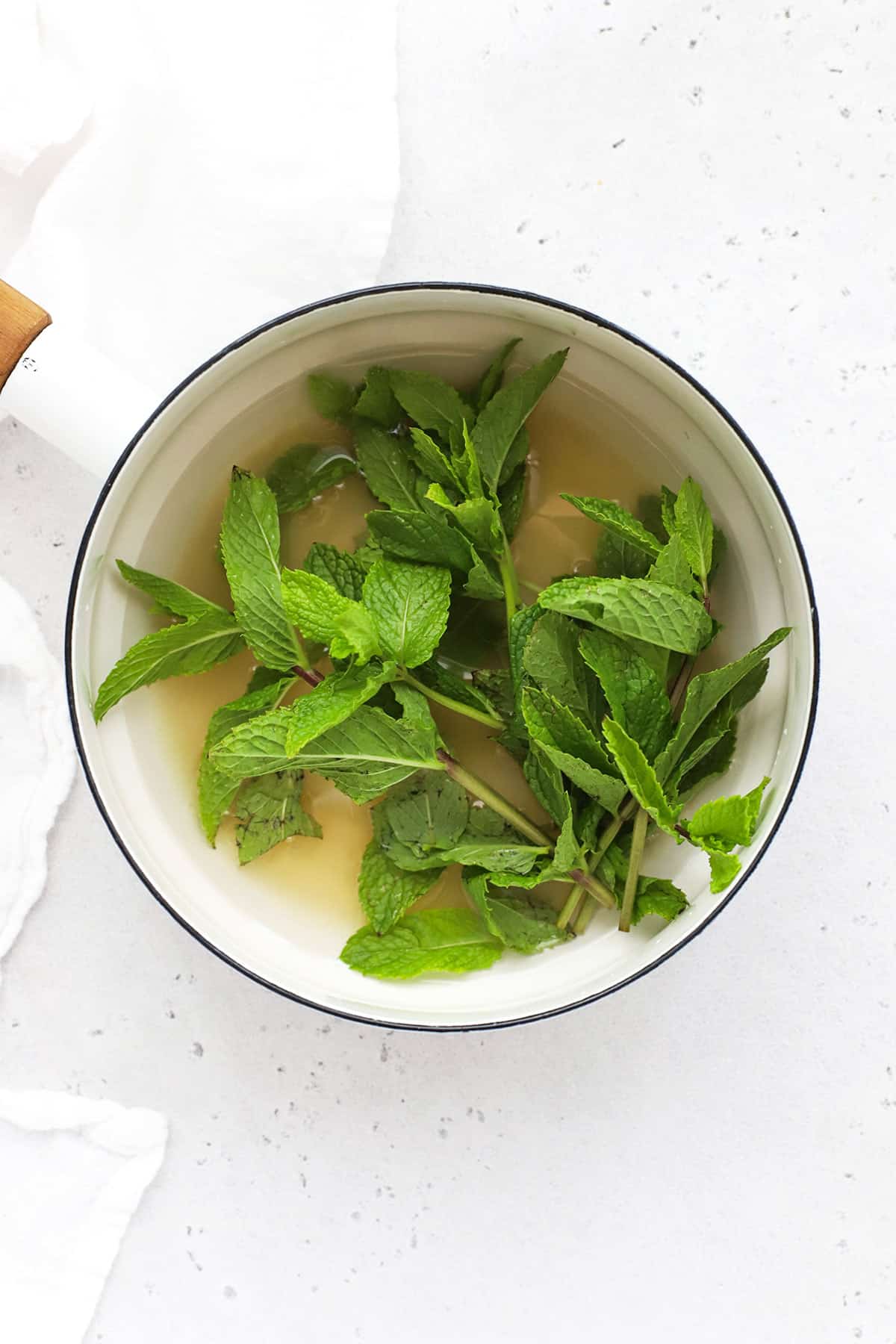 Steeping mint leaves to make mint simple syrup