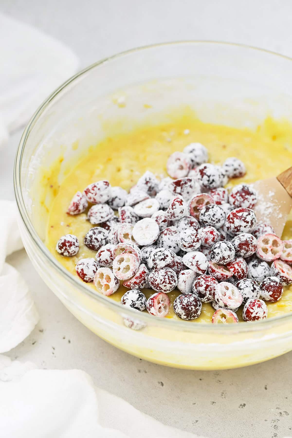 Adding cranberries coated with cornstarch to gluten-free orange cranberry cake batter
