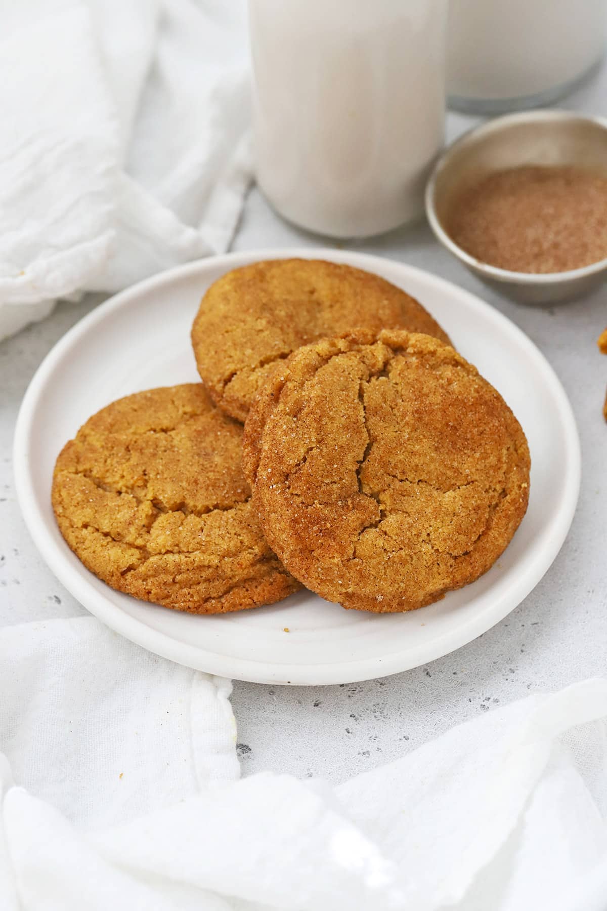 Front view of gluten-free pumpkin snickerdoodles on a white plate