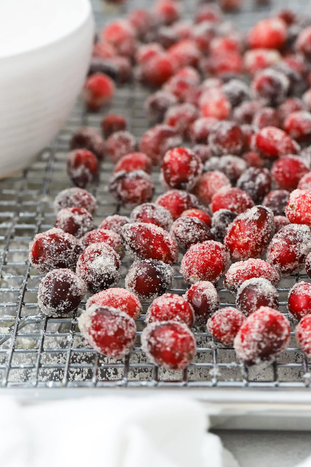 Front view of sugar covered cranberries on a wire rack