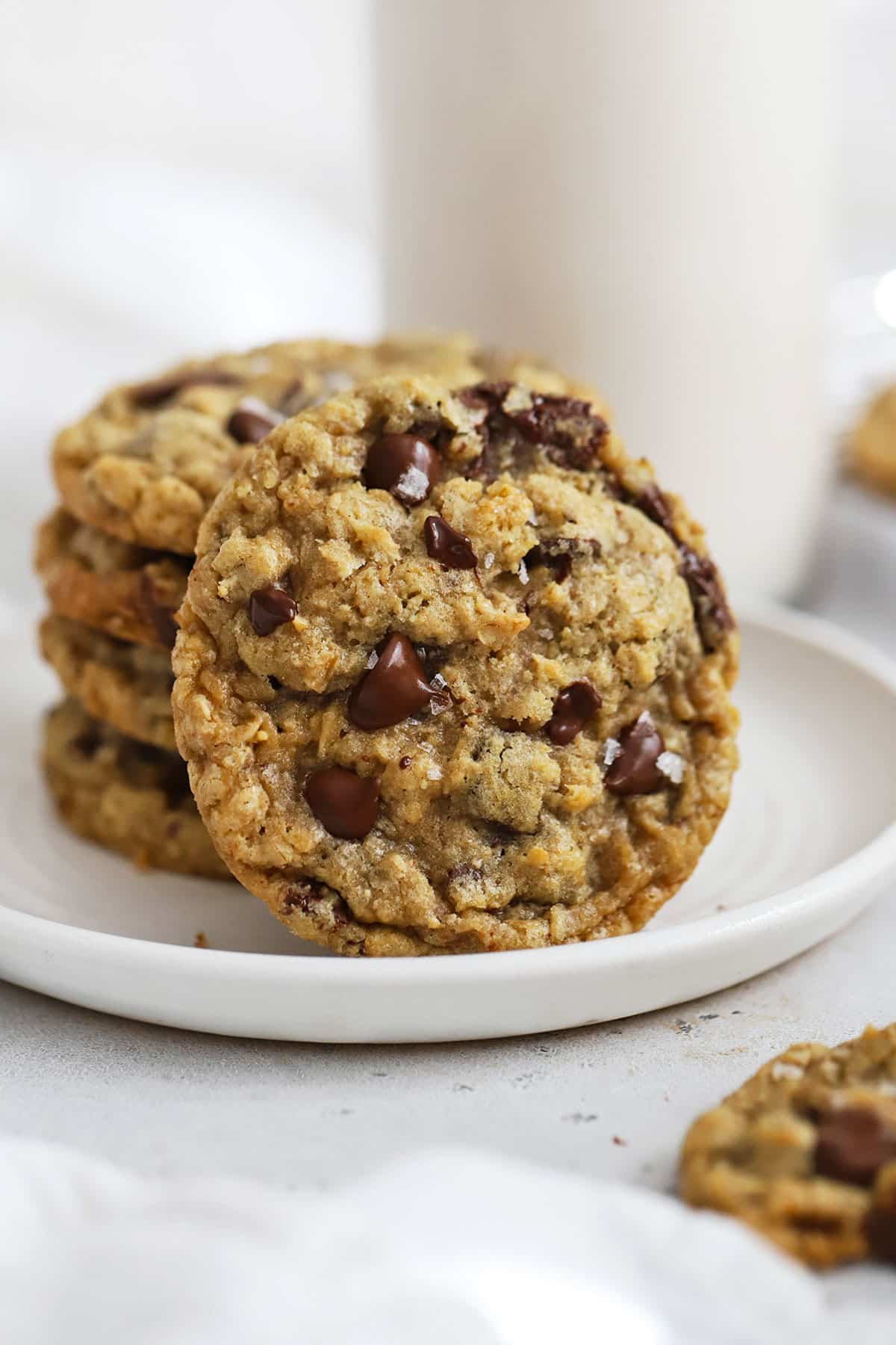 Gluten-Free Oatmeal Chocolate Chip Cookies stacked on a white plate