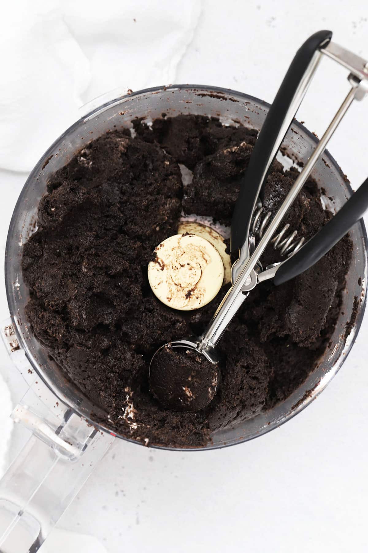 Scooping gluten-free Oreo truffles with a small cookie scoop