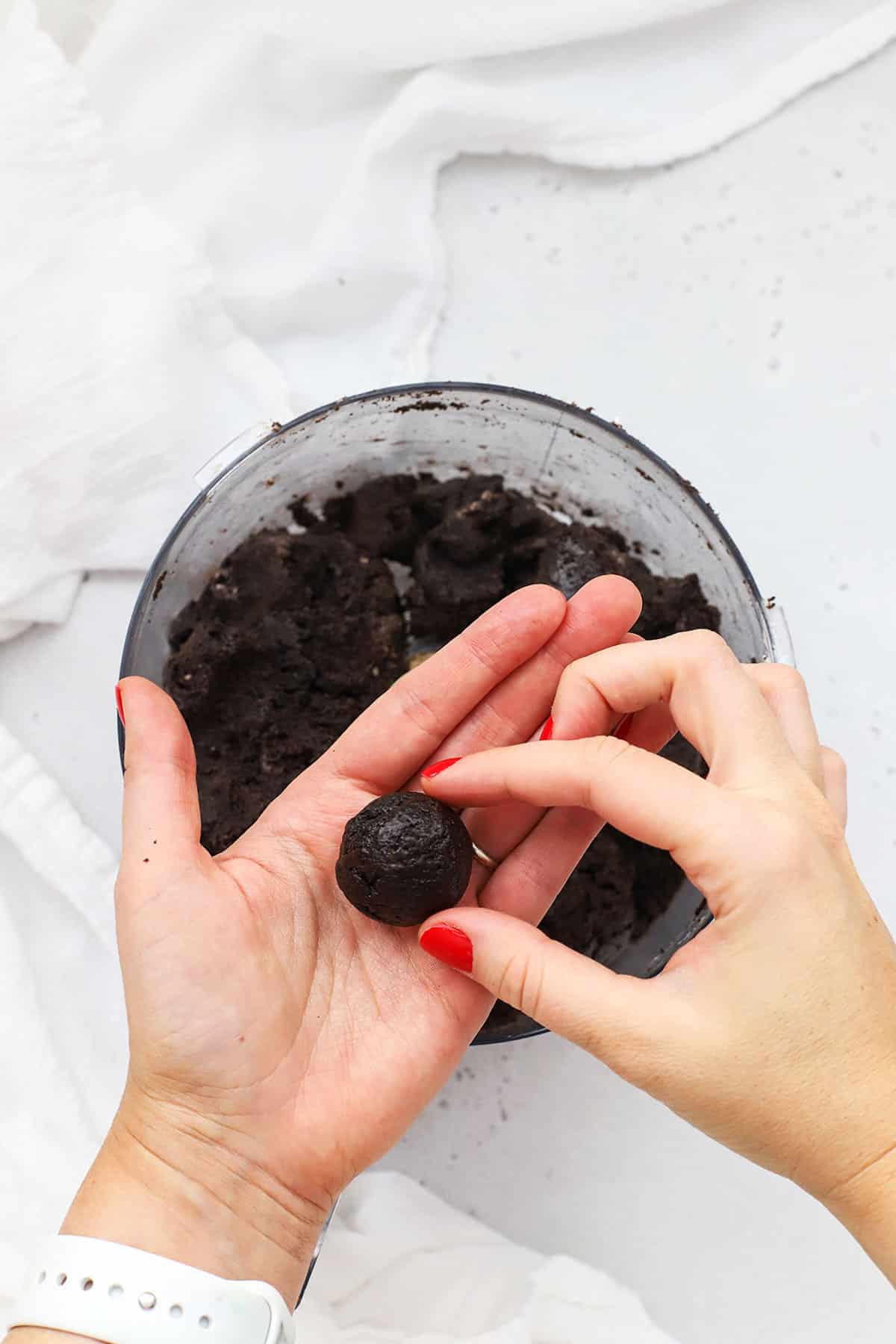 Rolling out gluten-free Oreo truffles into smooth balls