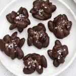 Chocolate almond clusters on a white plate