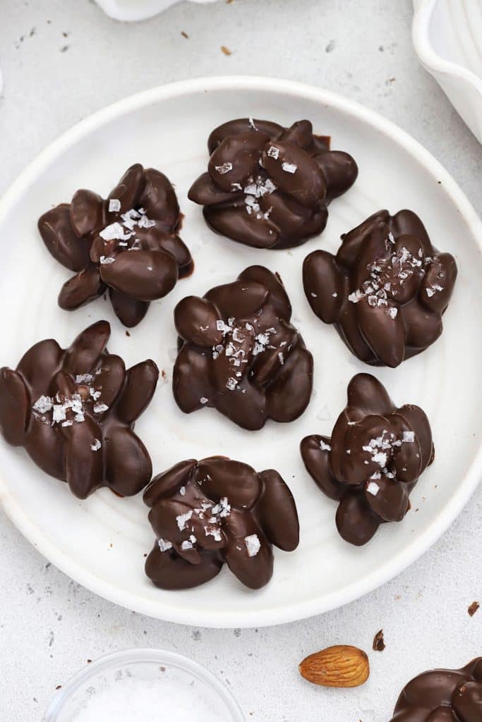 Chocolate almond clusters on a white plate