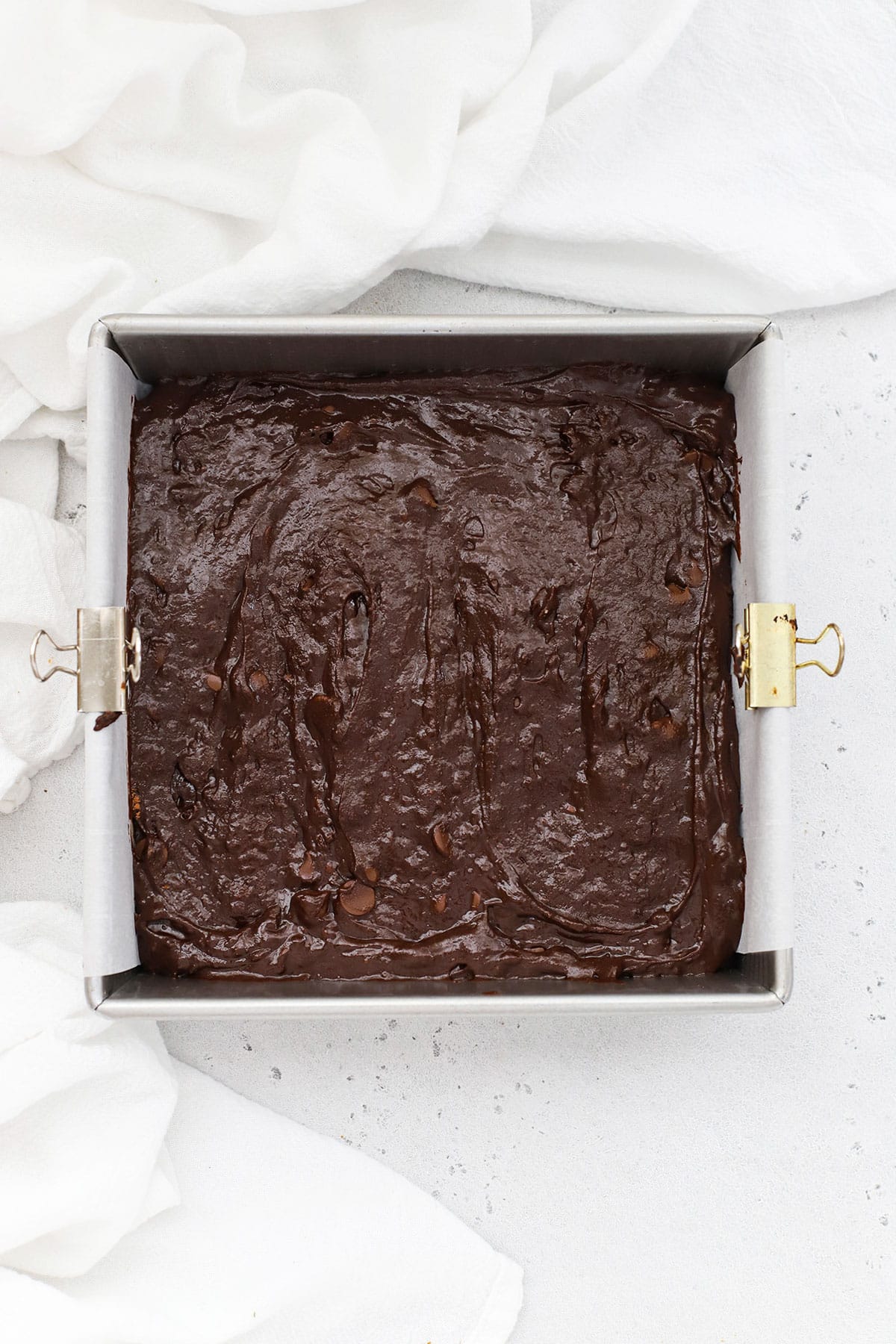 Gluten-free vegan brownie batter in a square metal pan