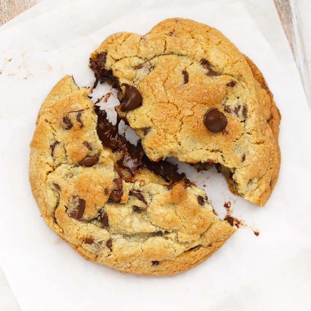 gluten free levain chocolate chip cookie being pulled apart to reveal a gooey center