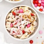 Gluten-free Valentines Chex Mix with red, white, and pink m&ms in a white bowl