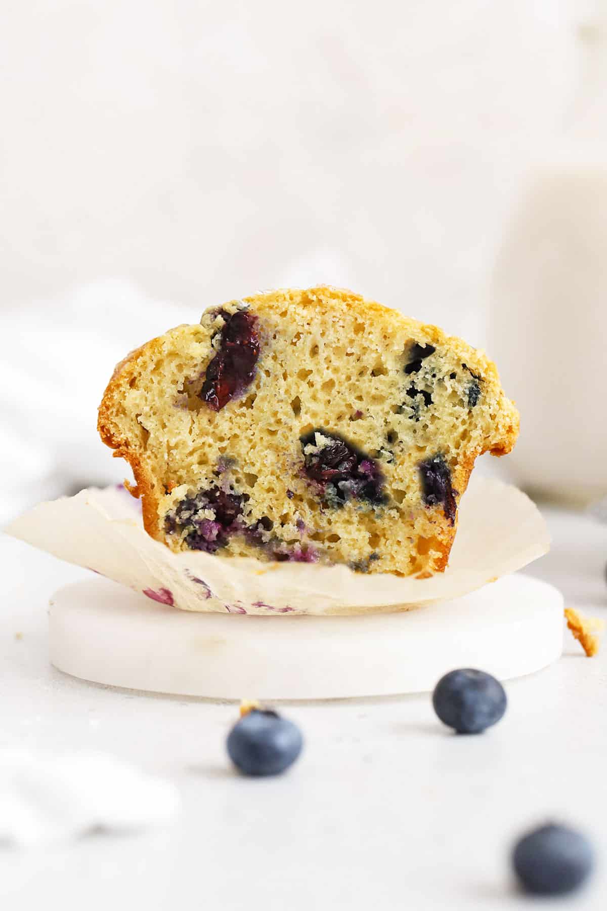gluten-free blueberry muffin cut in half to reveal a fluffy texture